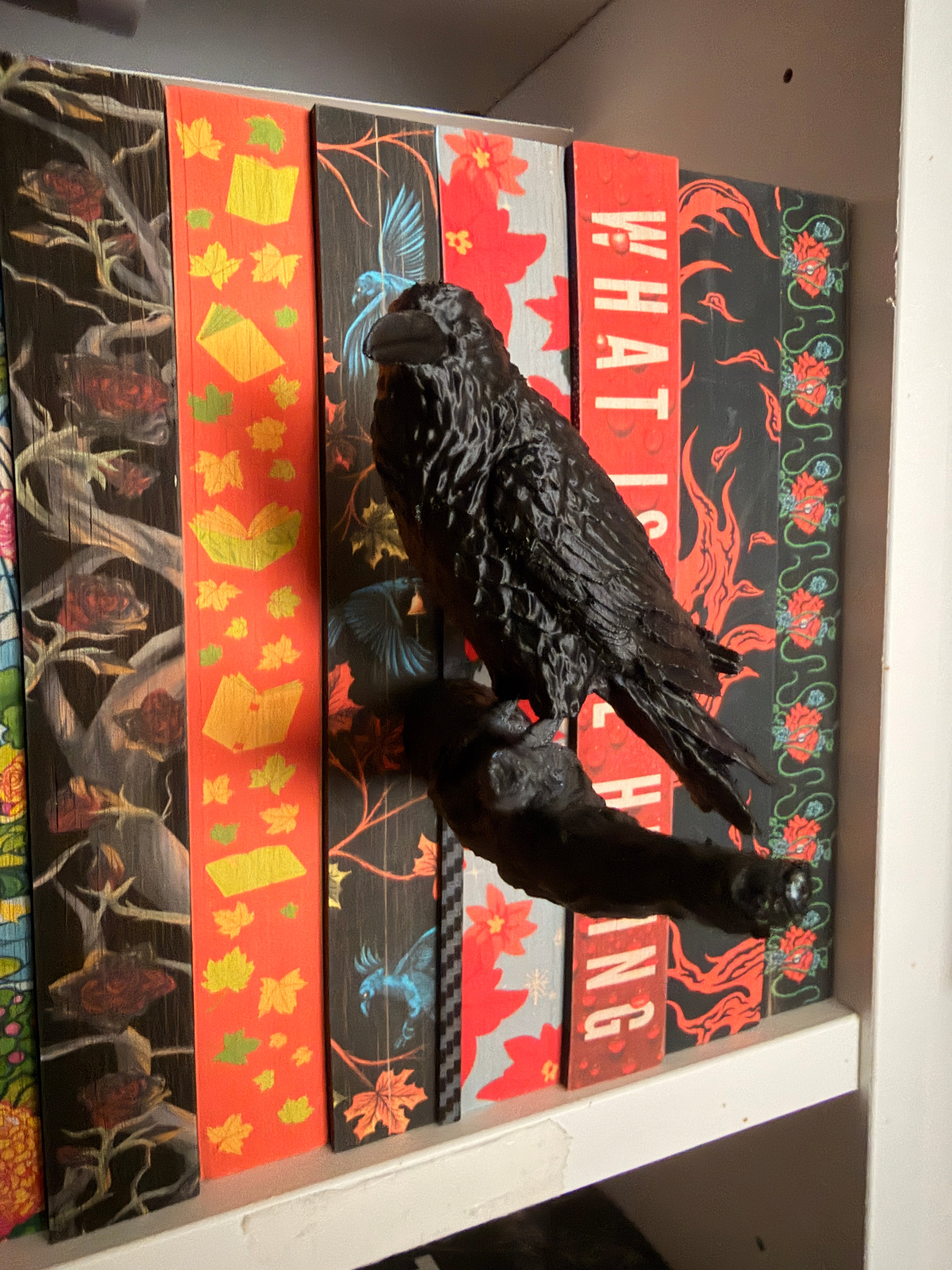 Black raven on a branch